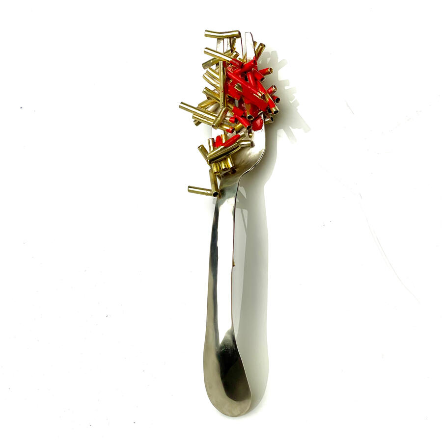 Something on your shirt fork with macaroni and hot sauce brooch